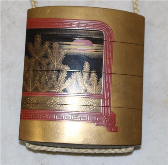 A Japanese togidashi lacquer three case inro, signed Koma Koryu Saku and kakihan, 19th century, losses to decoration on netsuke